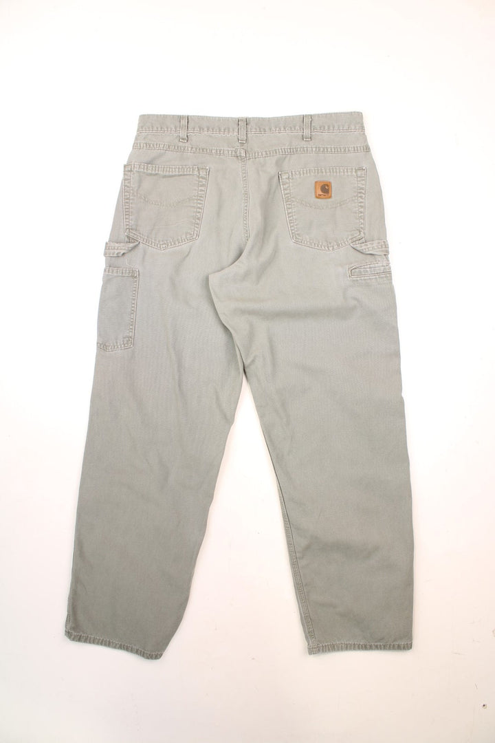 Carhartt Carpenter Jeans in a light khaki green colourway with multiple pockets and the logo embroidered on the back. 