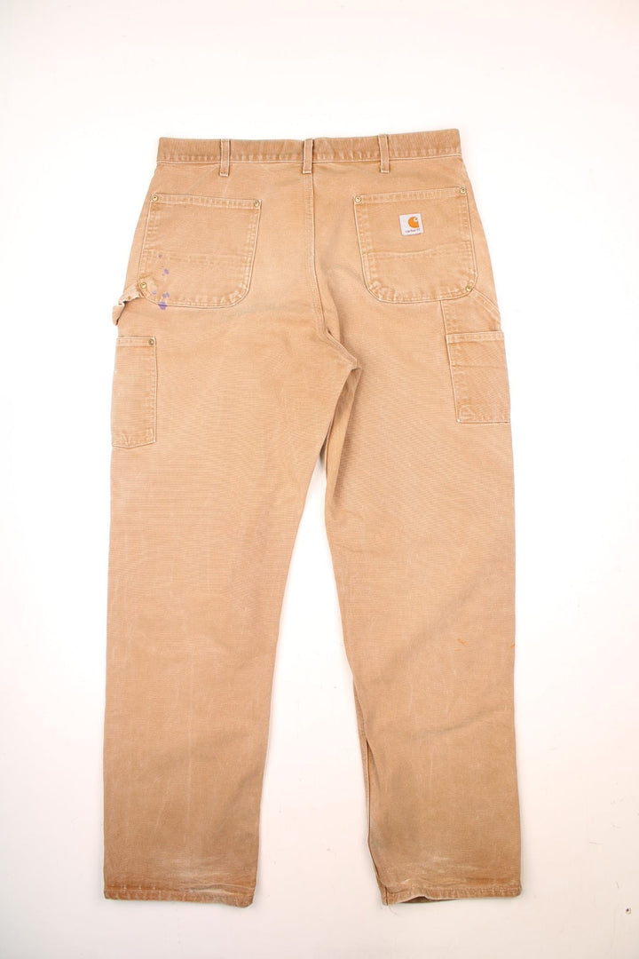 Carhartt Double Knee Jeans in a tanned colourway with multiple pockets and the logo embroidered on the front. 