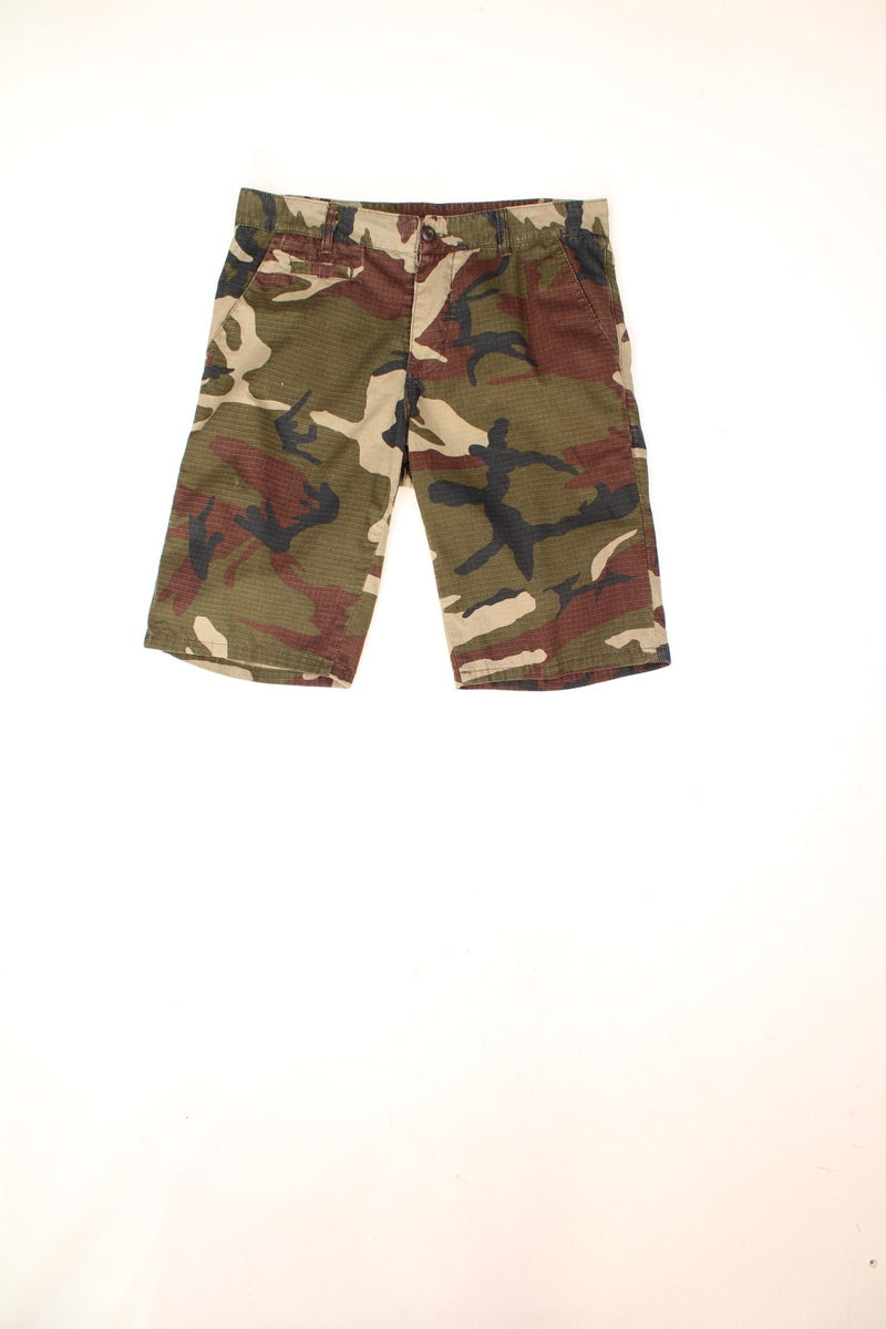 Carhartt Camo Shorts in a green, brown and black colourway with multiple pockets and the logo embroidered on the back. 