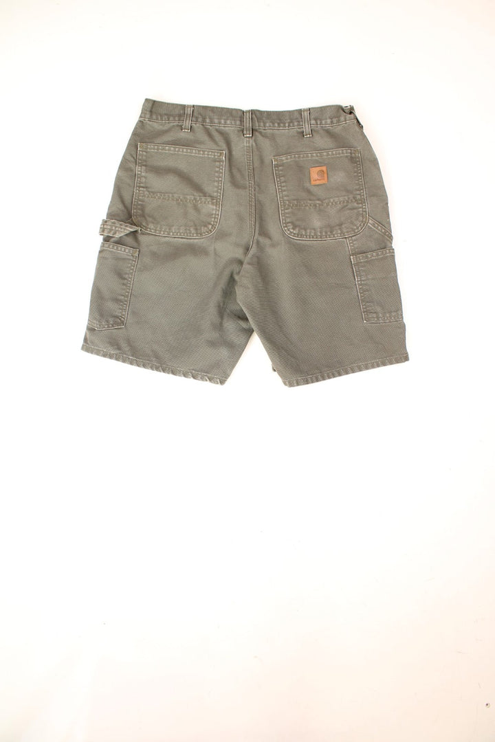 Carhartt Carpenter Shorts in a khaki green colourway with multiple pockets and the logo embroidered on the back. 