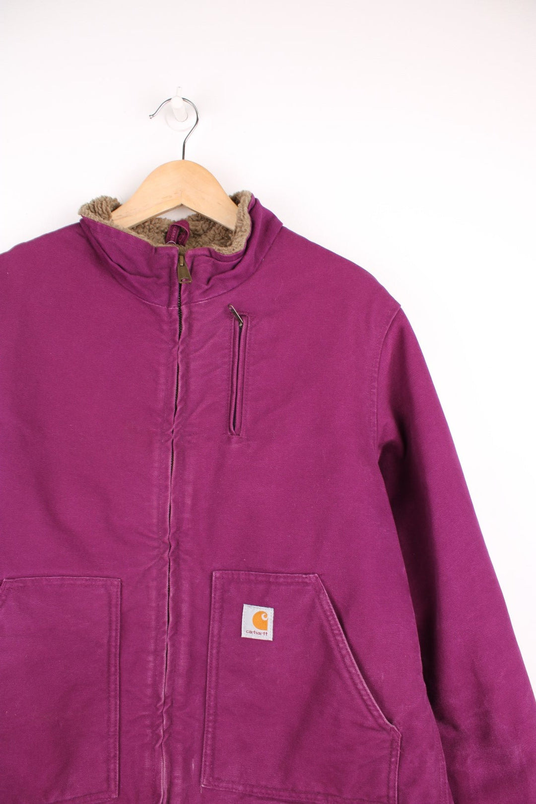 Carhart Detroit Jacket in a purple colourway, zip up with multiple pockets, sherpa lining, and has the logo embroidered on the front. 