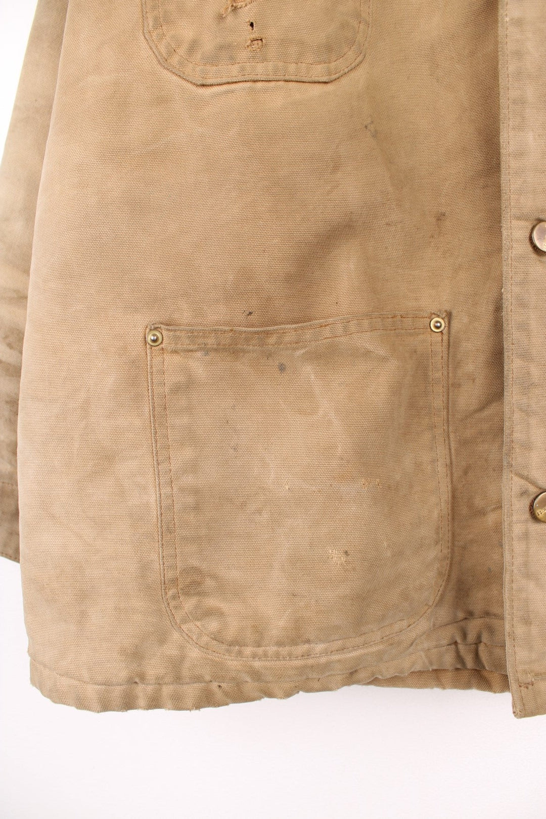 Carhartt Chore Jacket in a tanned colourway with a brown corduroy collar, button up with multiple pockets, blanket lining, and has the logo embroidered on the front. 