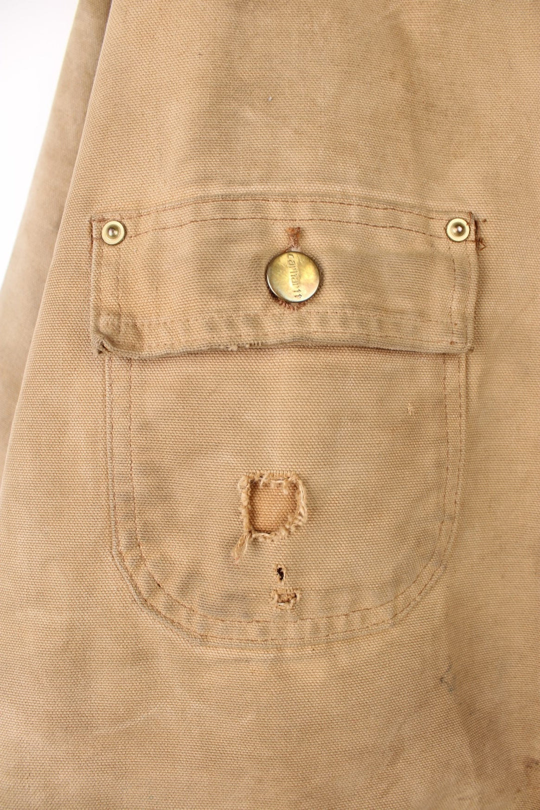 Carhartt Chore Jacket in a tanned colourway with a brown corduroy collar, button up with multiple pockets, blanket lining, and has the logo embroidered on the front. 