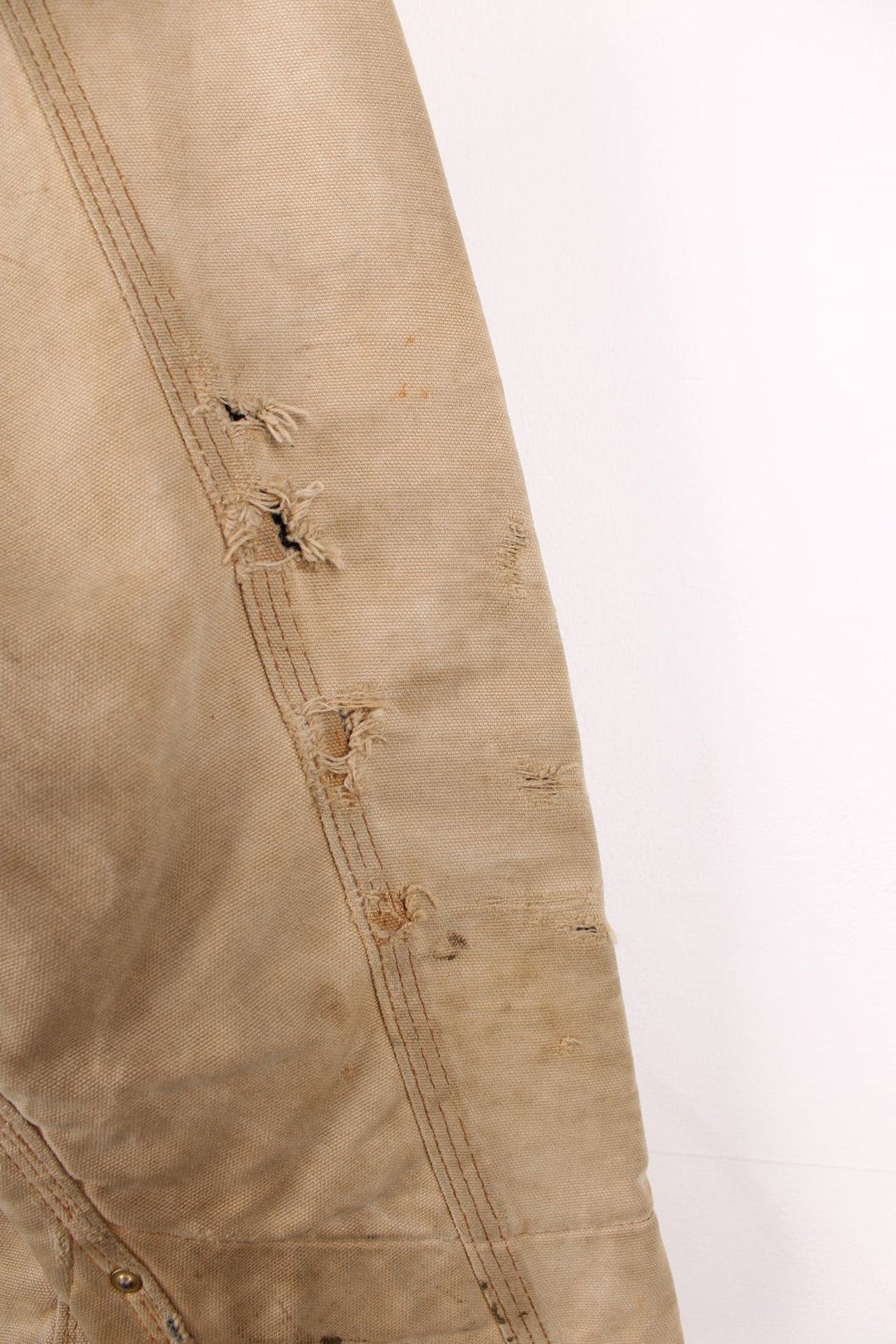 Carhartt Chore Jacket in a tanned colourway with a brown corduroy collar, button up with multiple pockets, blanket lining, and has the logo embroidered on the front. 