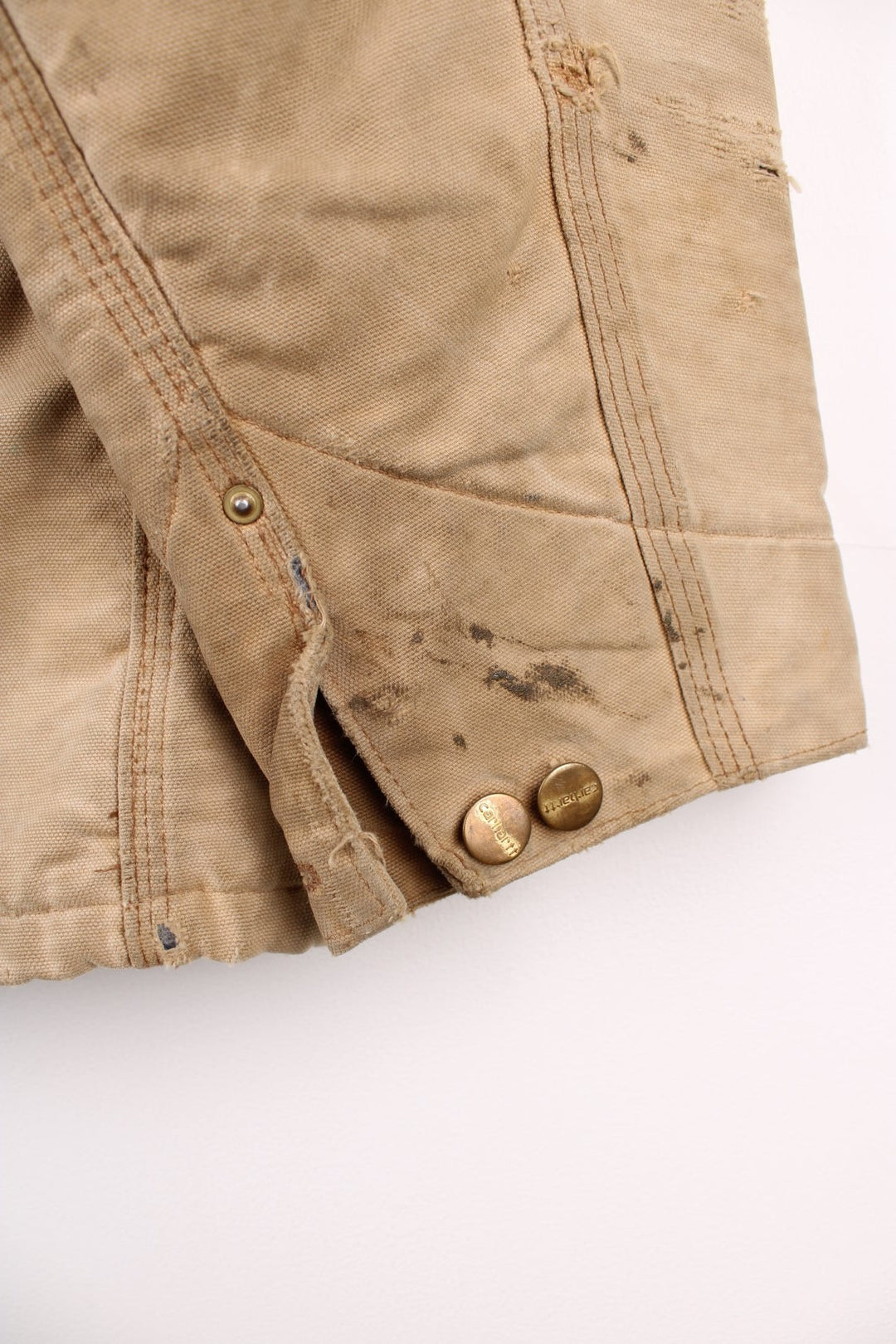 Carhartt Chore Jacket in a tanned colourway with a brown corduroy collar, button up with multiple pockets, blanket lining, and has the logo embroidered on the front. 