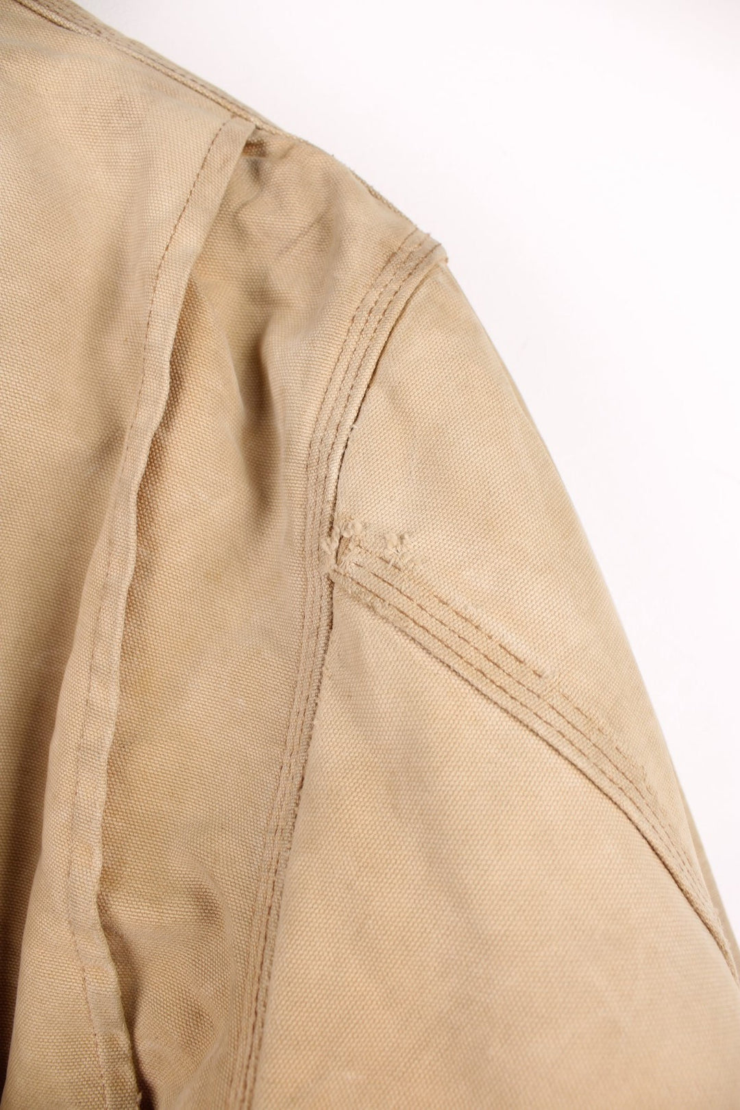 Carhartt Chore Jacket in a tanned colourway with a brown corduroy collar, button up with multiple pockets, blanket lining, and has the logo embroidered on the front. 