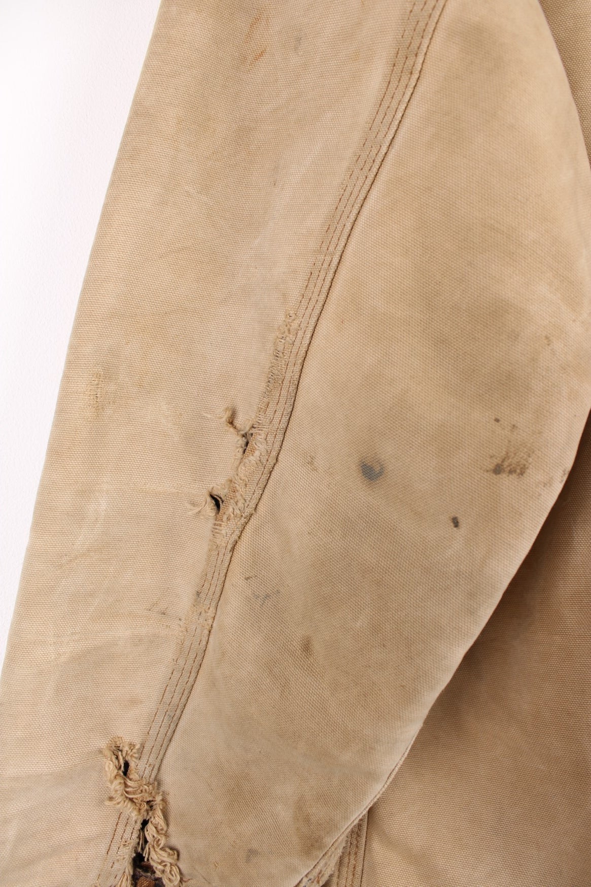 Carhartt Chore Jacket in a tanned colourway with a brown corduroy collar, button up with multiple pockets, blanket lining, and has the logo embroidered on the front. 