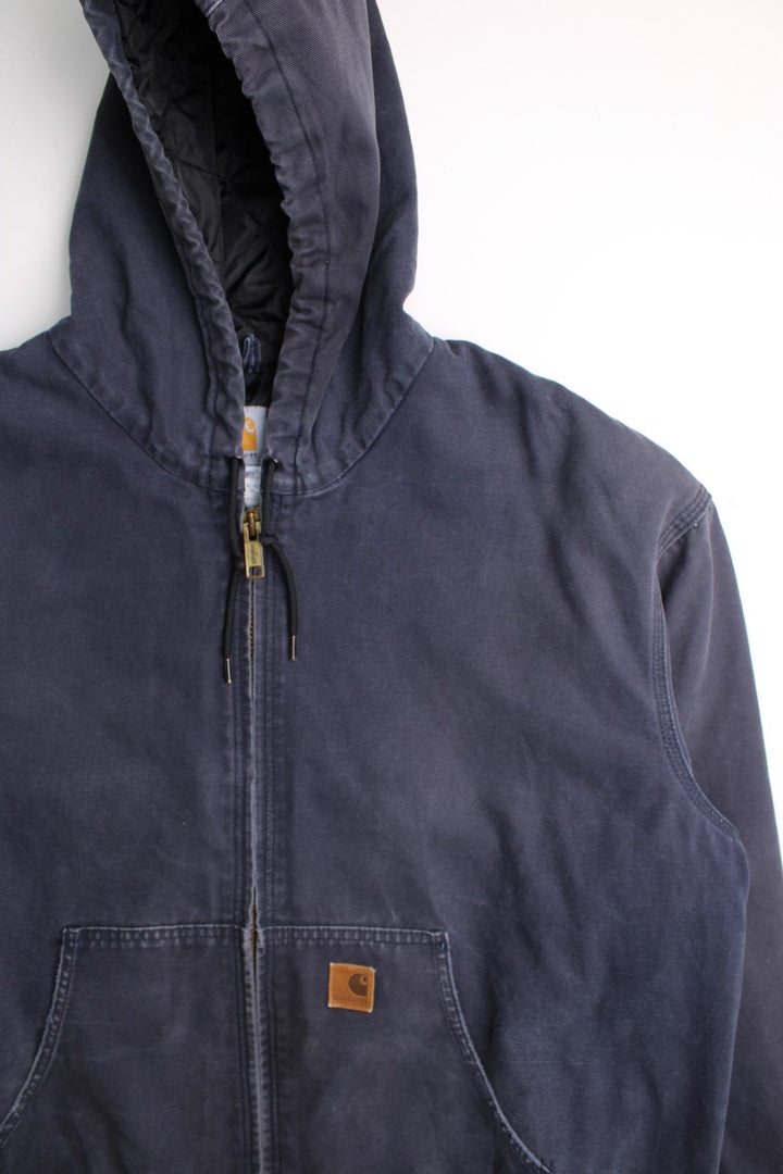 Carhartt Active Jacket in a blue colourway. Zips up and has side pockets, hooded, and has the logos embroidered on the front.