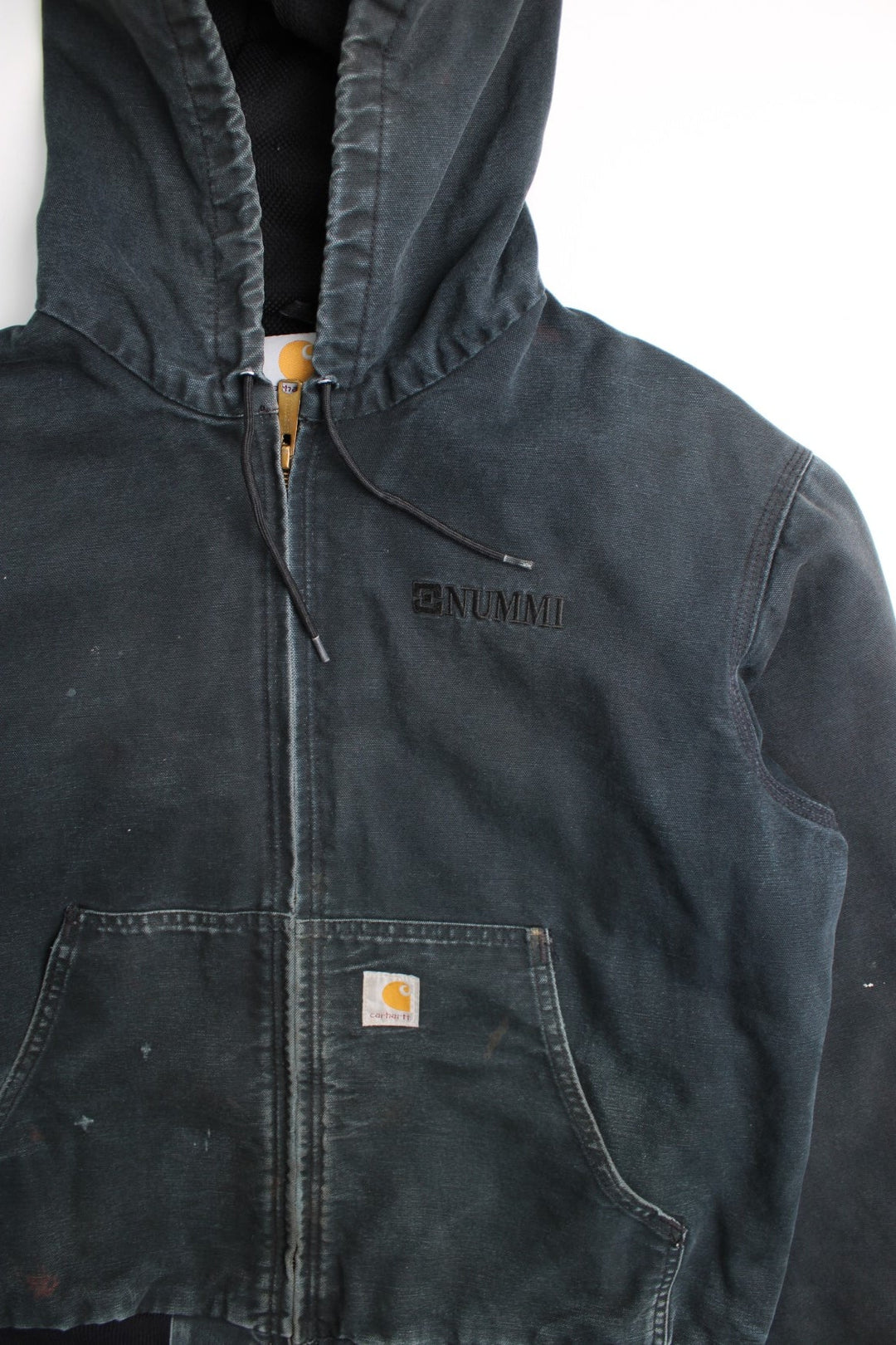 Carhartt Active Jacket in a black colourway. Zips up and has side pockets, hooded, has 'Nummi' business spell out logo embroidered on the front and Carhartt logo embroidered on the pocket.