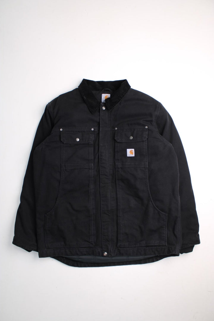 Carhartt Arctic Jacket in a black colourway. Zip and button up with multiple pockets, corduroy collar, and has the logo embroidered on the front.