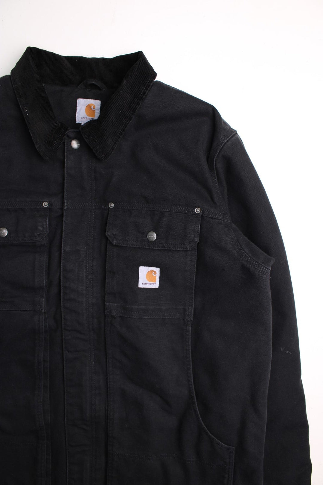 Carhartt Arctic Jacket in a black colourway. Zip and button up with multiple pockets, corduroy collar, and has the logo embroidered on the front.