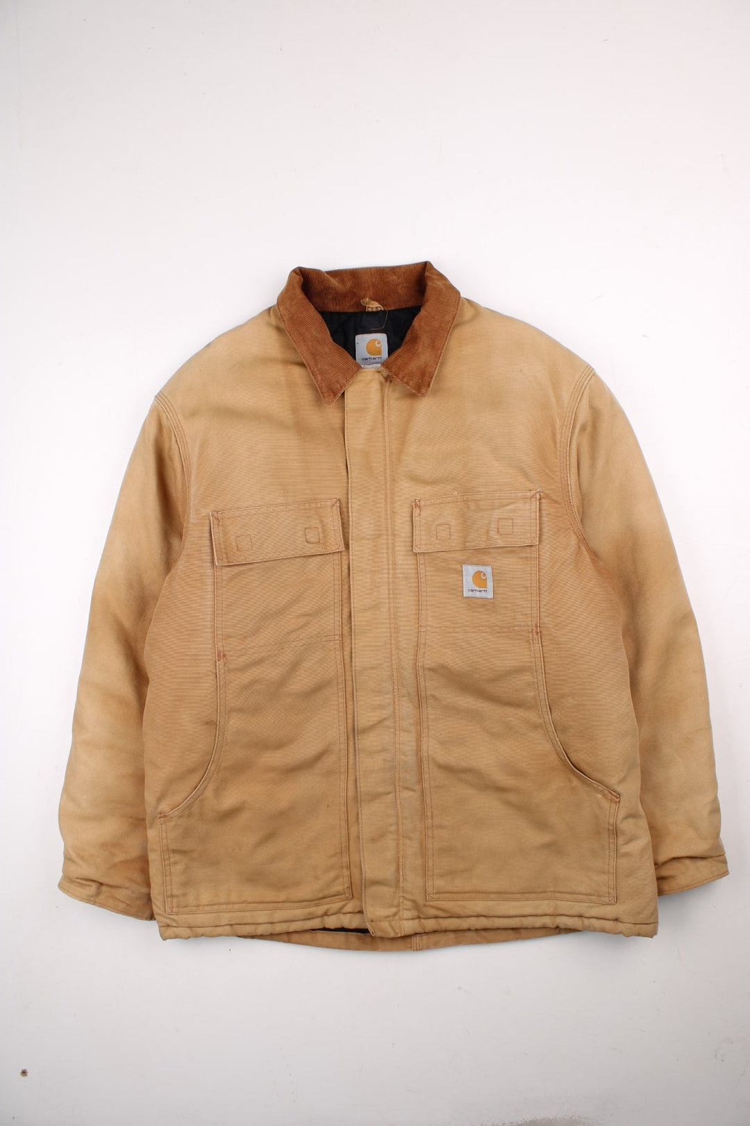 Carhartt Arctic Jacket in a tan colourway. Zips up and has multiple pockets, corduroy collar, insulated with a quilted lining, and has the logo embroidered on the front.