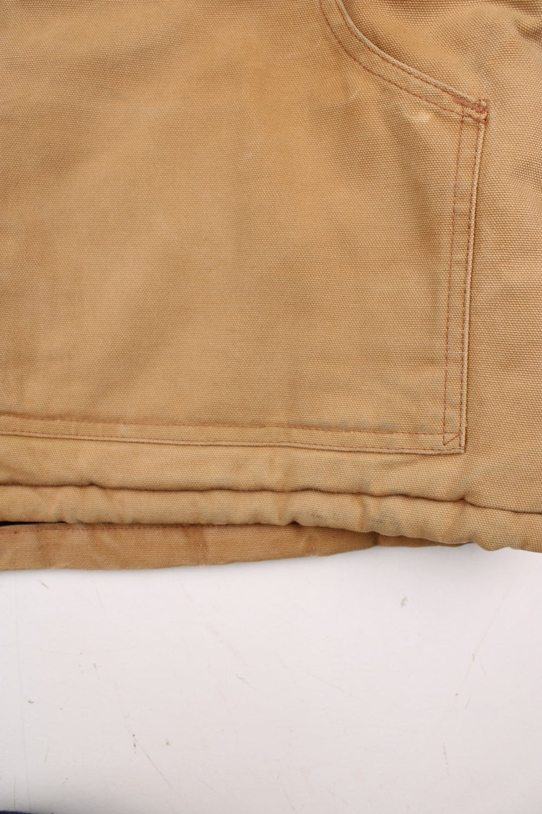 Carhartt Arctic Jacket in a tan colourway. Zips up and has multiple pockets, corduroy collar, insulated with a quilted lining, and has the logo embroidered on the front.