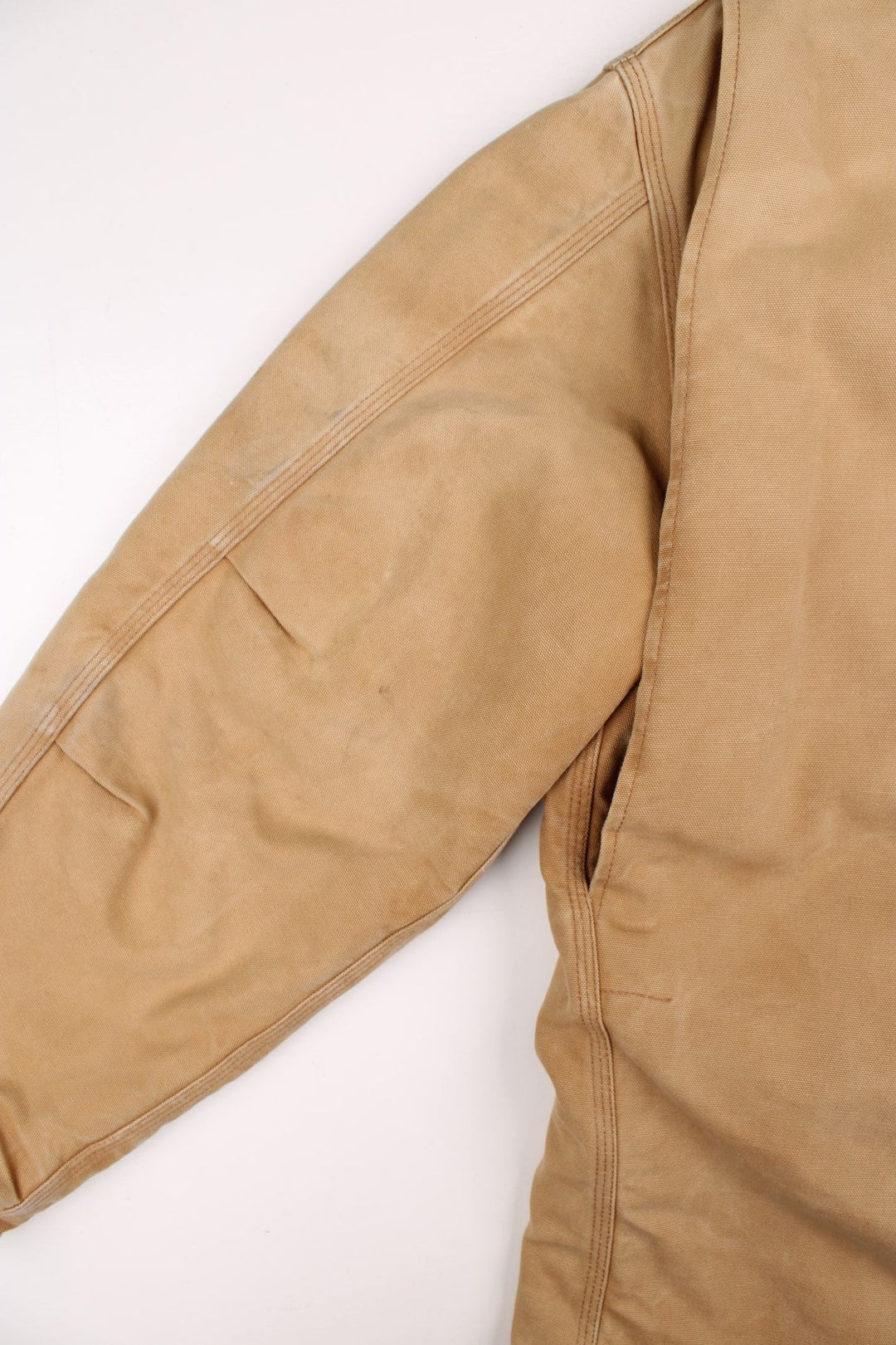 Carhartt Arctic Jacket in a tan colourway. Zips up and has multiple pockets, corduroy collar, insulated with a quilted lining, and has the logo embroidered on the front.