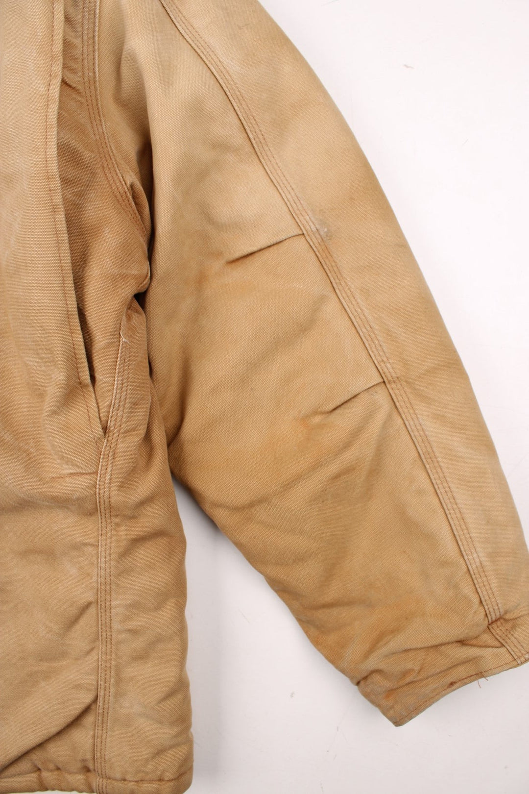 Carhartt Arctic Jacket in a tan colourway. Zips up and has multiple pockets, corduroy collar, insulated with a quilted lining, and has the logo embroidered on the front.