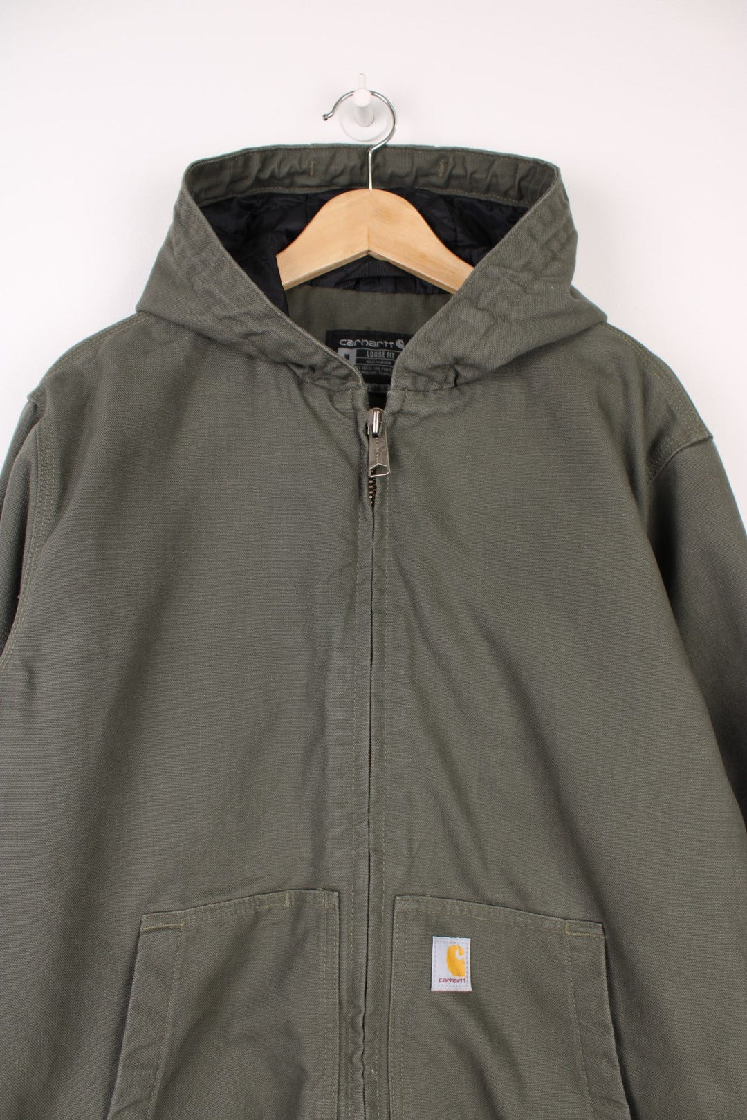 Carhartt Active Jacket in a khaki green colourway, zip up with side pockets, insulated with a quilted lining, hooded, and has the logo embroidered on the front. 