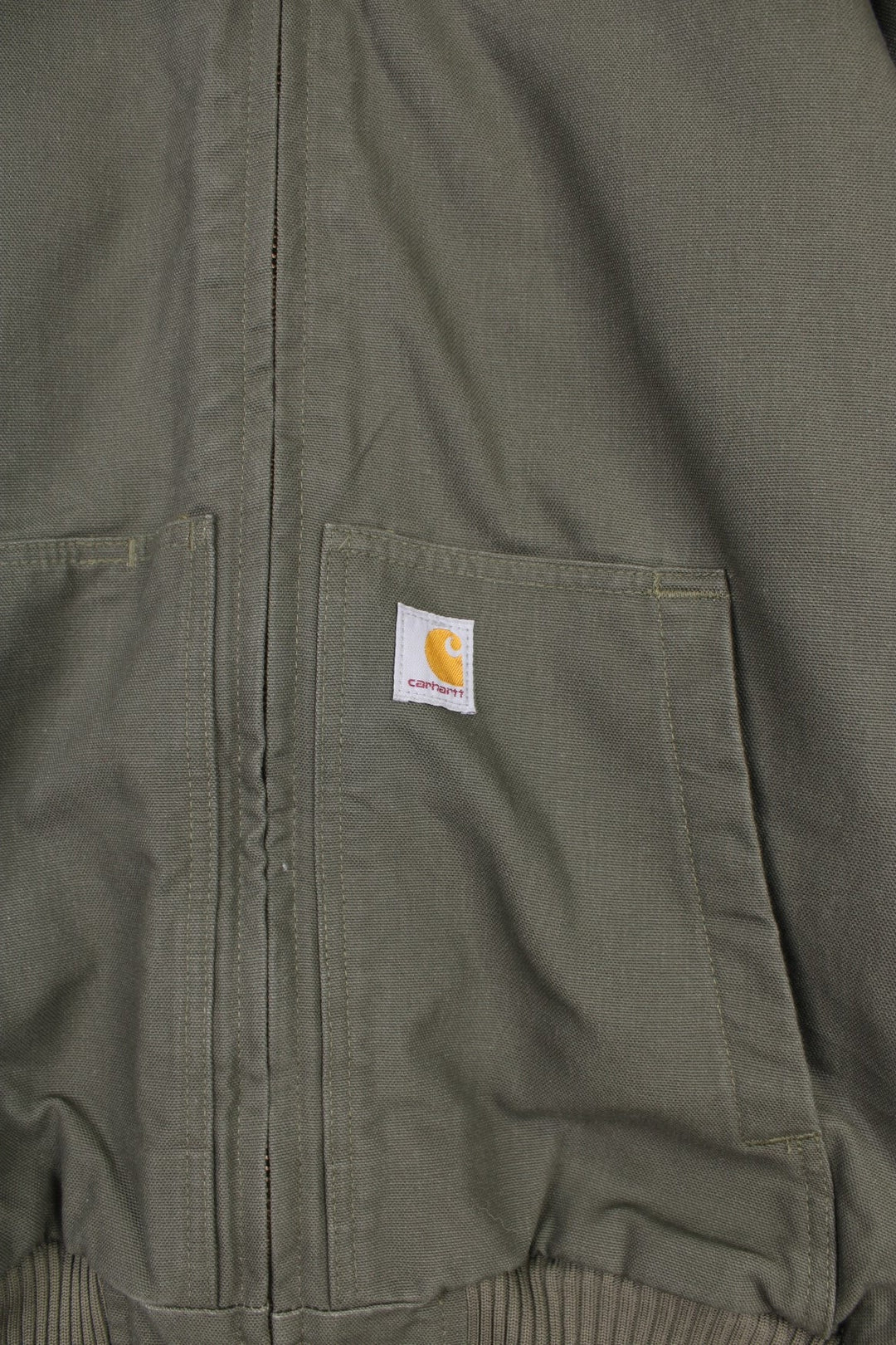 Carhartt Active Jacket in a khaki green colourway, zip up with side pockets, insulated with a quilted lining, hooded, and has the logo embroidered on the front. 