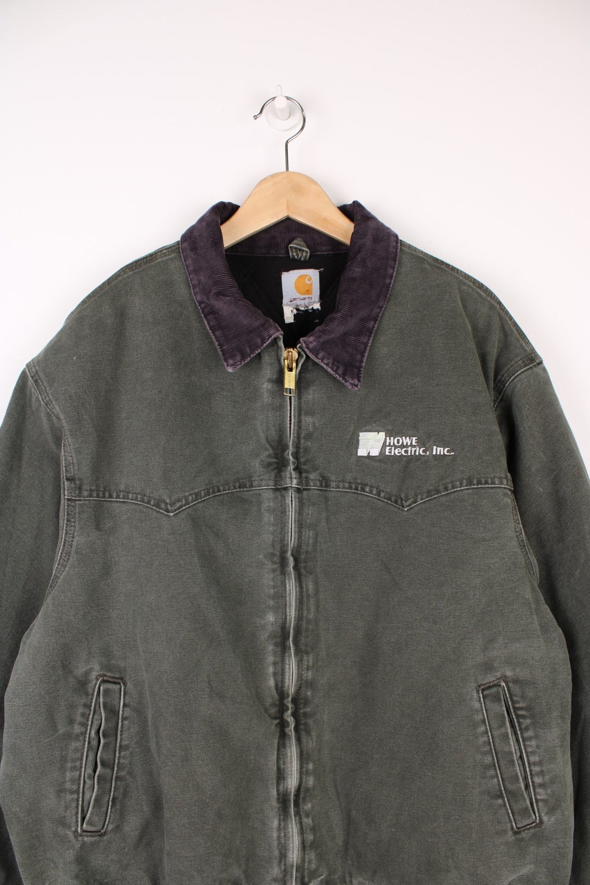 Carhartt Santa Fe Jacket in a khaki green colourway with a purple corduroy collar, zip up with side pockets, and has &