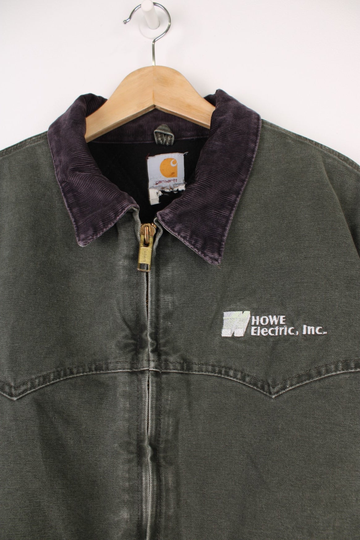 Carhartt Santa Fe Jacket in a khaki green colourway with a purple corduroy collar, zip up with side pockets, and has &