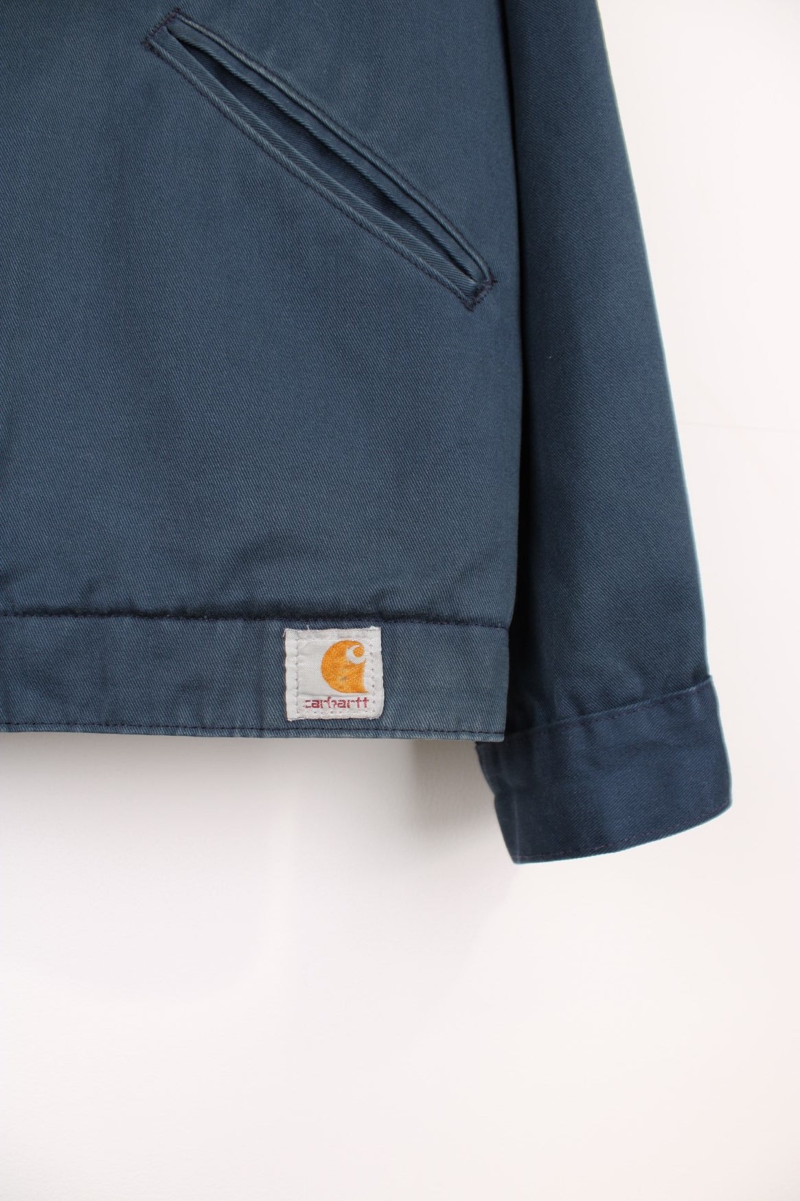 Carhartt Workwear Canvas Jacket in a blue colourway, zip up with side pockets, has a quilted lining, and the logo embroiderd on the front. 