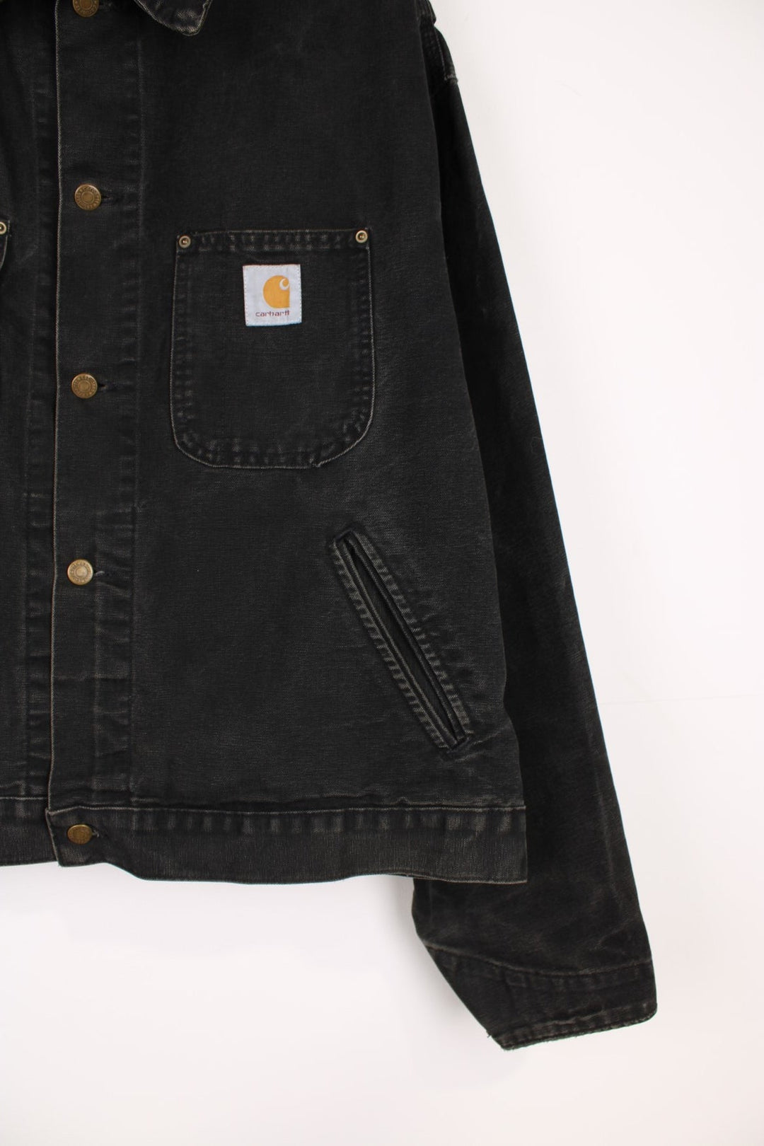 Vintage 90's Carhartt Saledo Denim Jacket in a faded black colourway, button up with multiple pockets, and has the logo embroidered on the front. 