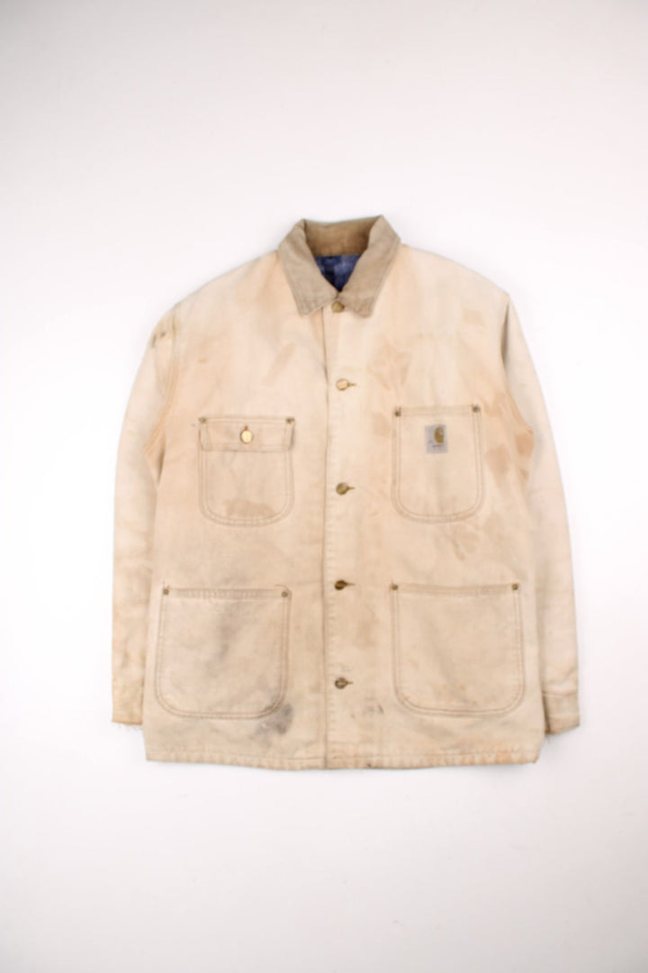 Vintage 70's Carhartt Distressed Chore Jacket in a tan colourway. Buttons up and has multiple pockets, blanket lining, corduroy collar, and has the logo embroidered on the front.