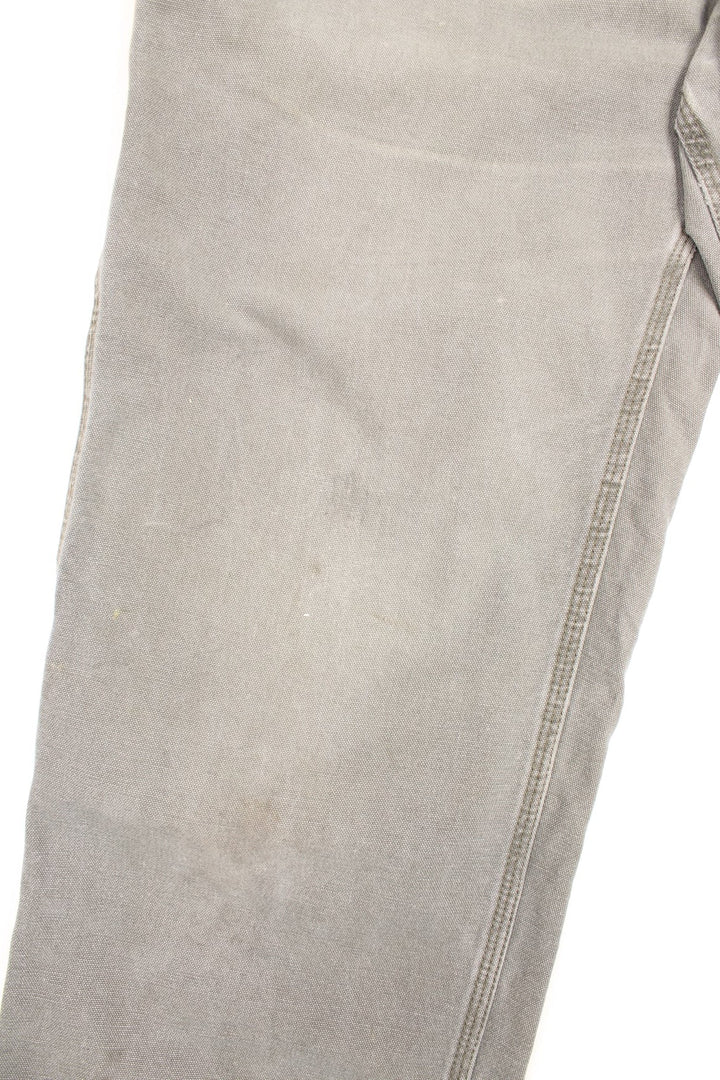 Carhartt Carpenter Jeans in a Khaki green colourway with multiple pockets and the logo embroidered on the back.