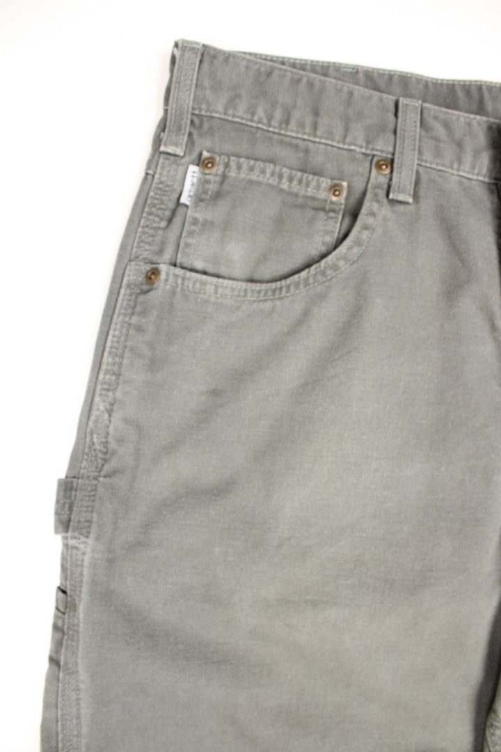 Carhartt Carpenter Jeans in a Khaki green colourway with multiple pockets and the logo embroidered on the back.