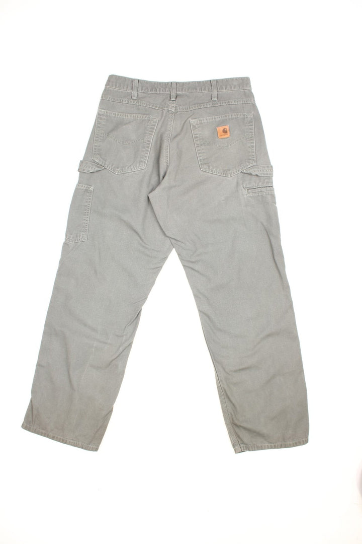 Carhartt Carpenter Jeans in a Khaki green colourway with multiple pockets and the logo embroidered on the back.