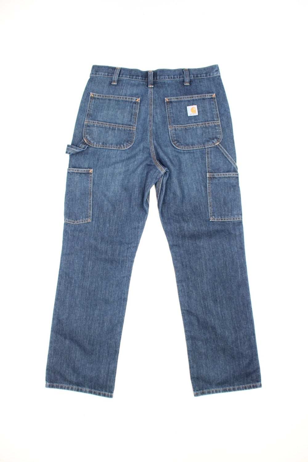 Carhartt Carpenter jeans in a dark blue denim, with multiple pockets and the logo embroidered on the back.