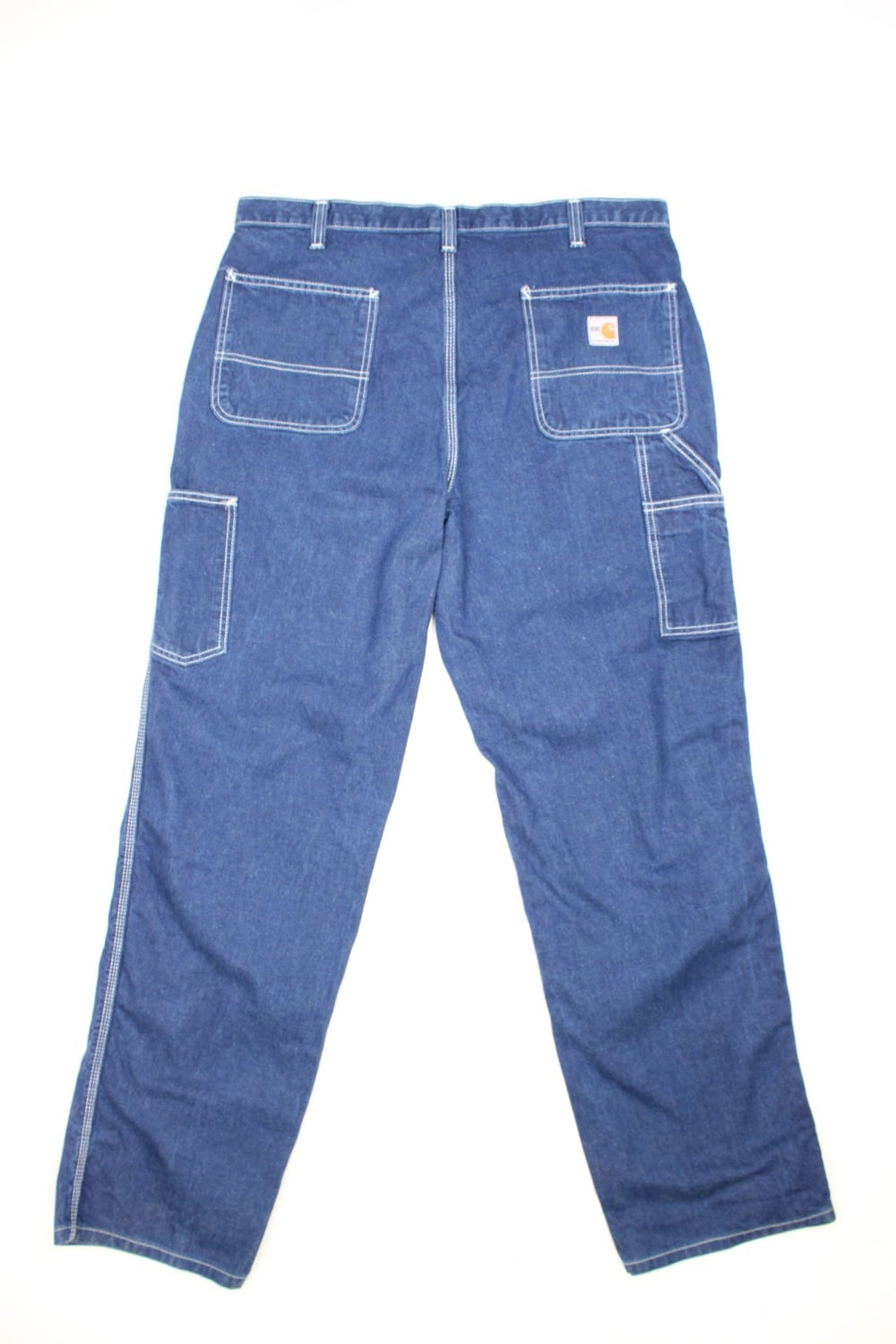 Carhartt Carpenter jeans in a dark blue denim, with white contrast stitching, multiple pockets and the logo embroidered on the back.