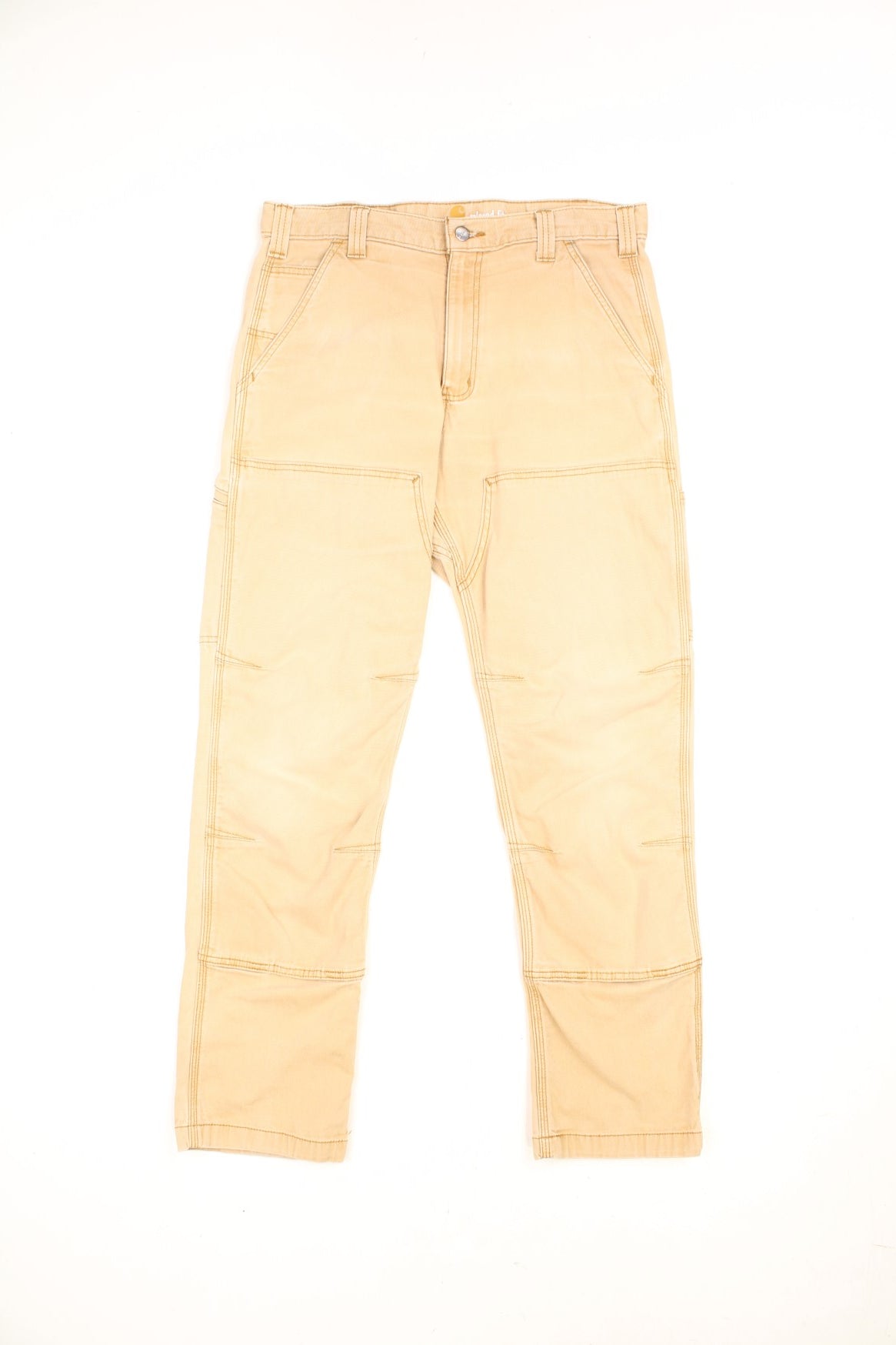 Carhartt tan relaxed fit carpenter jeans. Features double knees, multiple pockets and embroidered logo on the back