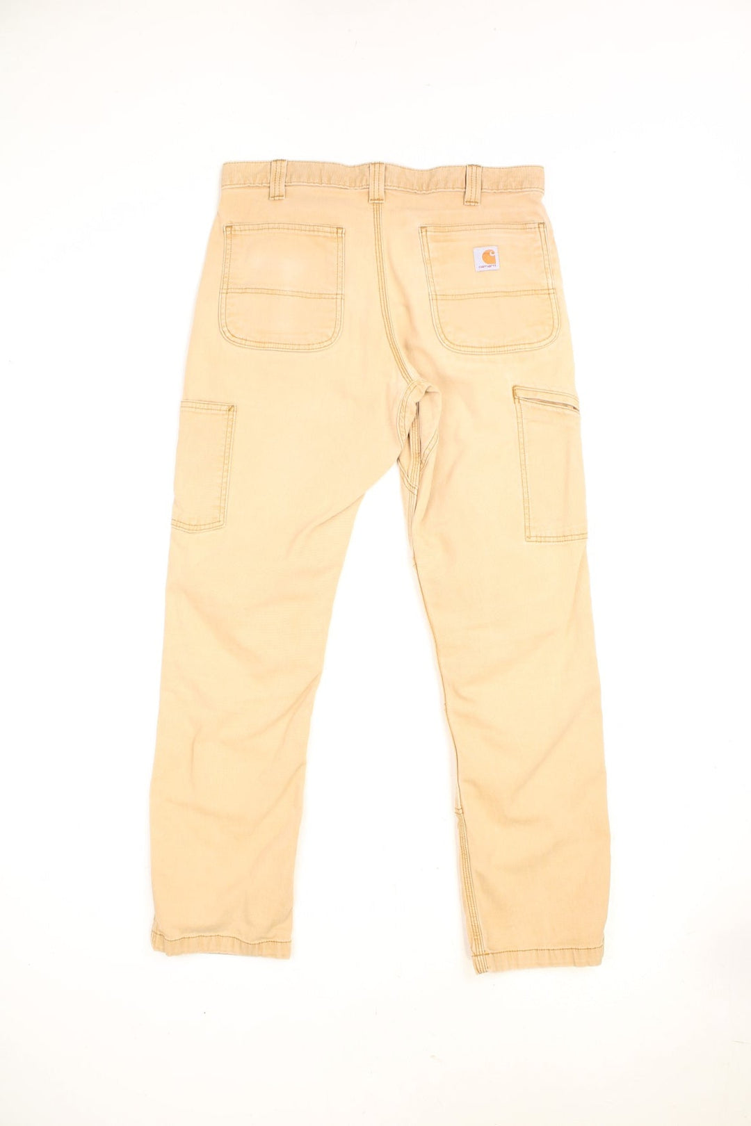 Carhartt tan relaxed fit carpenter jeans. Features double knees, multiple pockets and embroidered logo on the back