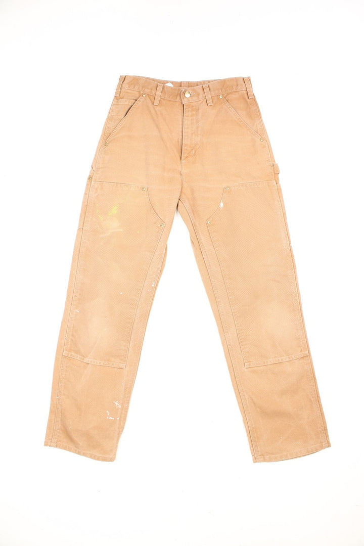 Carhartt brown dungaree fit carpenter jeans. Features double knees, multiple pockets and embroidered logo on the back