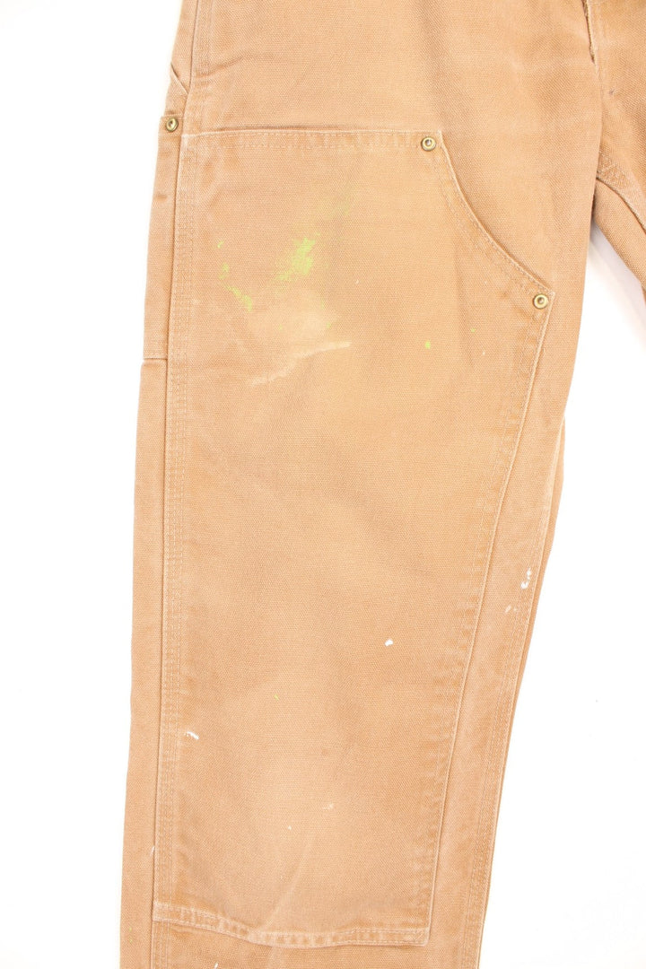 Carhartt brown dungaree fit carpenter jeans. Features double knees, multiple pockets and embroidered logo on the back