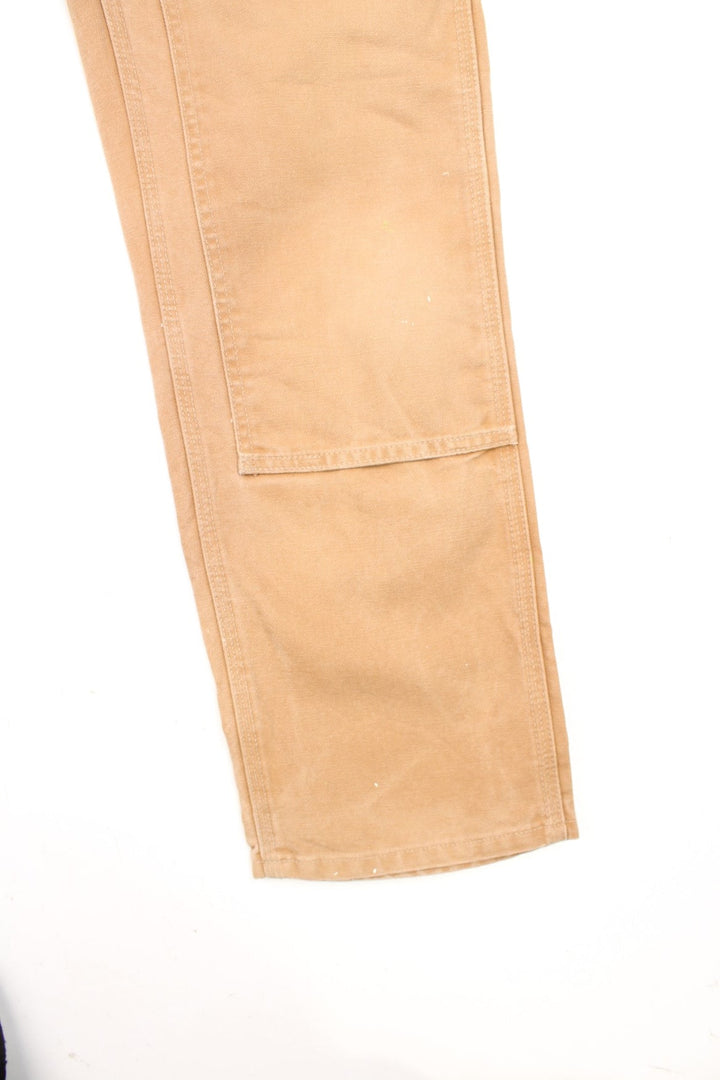 Carhartt brown dungaree fit carpenter jeans. Features double knees, multiple pockets and embroidered logo on the back