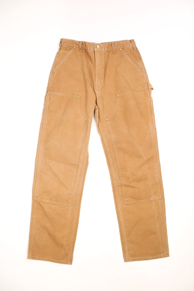 Carhartt brown loose original fit carpenter jeans. Features double knees, multiple pockets and embroidered logo on the back