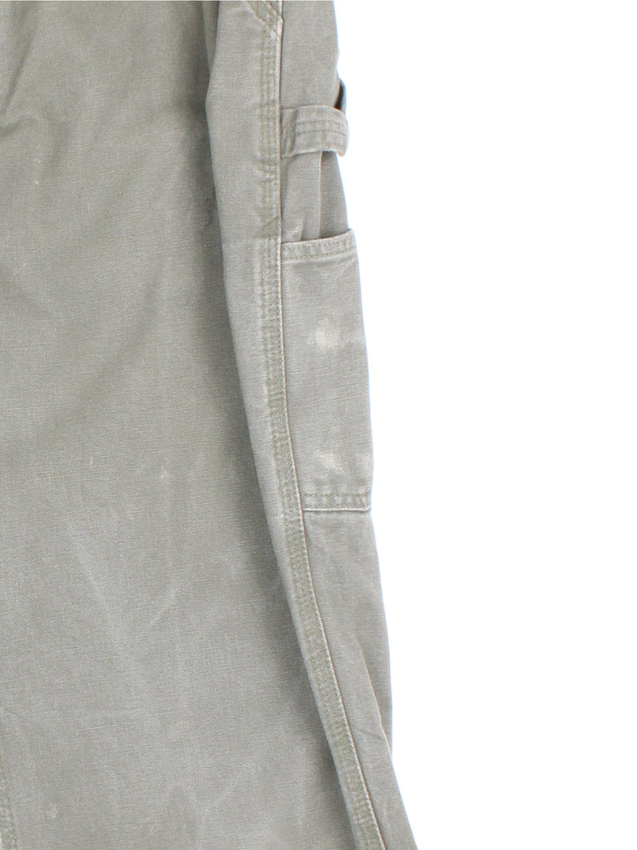 Carhartt Carpenter Jeans in a green colourway with multiple pockets and the logo embroidered on the back.