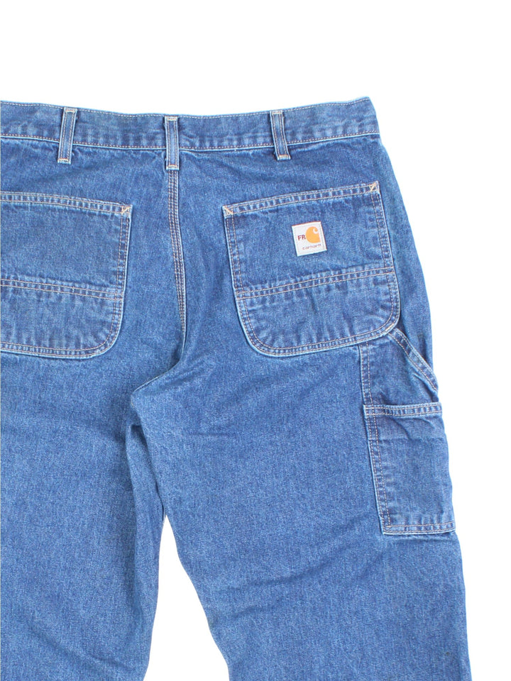 Carhartt Carpenter Jeans in a blue colourway with multiple pockets and the logo embroidered on the back.