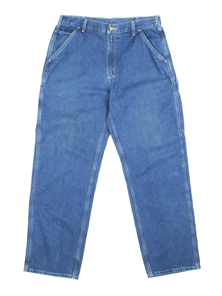 Carhartt Carpenter Jeans in a blue colourway with multiple pockets and the logo embroidered on the back.