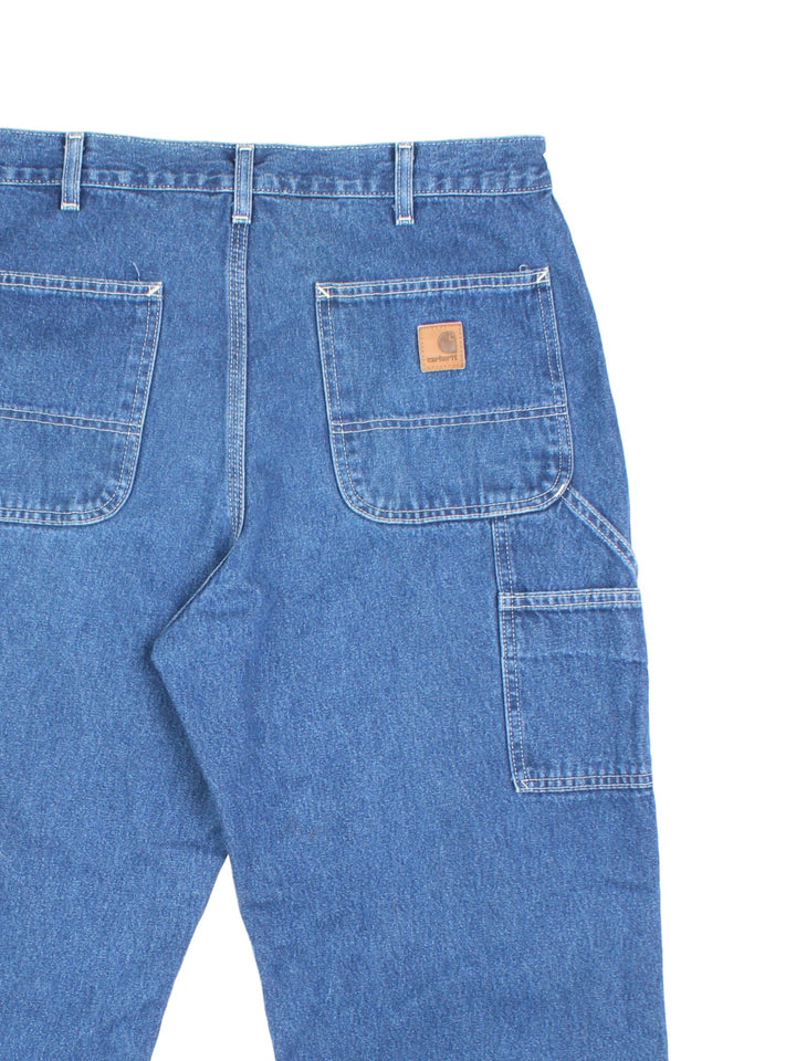 Carhartt Carpenter Jeans in a blue colourway with multiple pockets and the logo embroidered on the back.