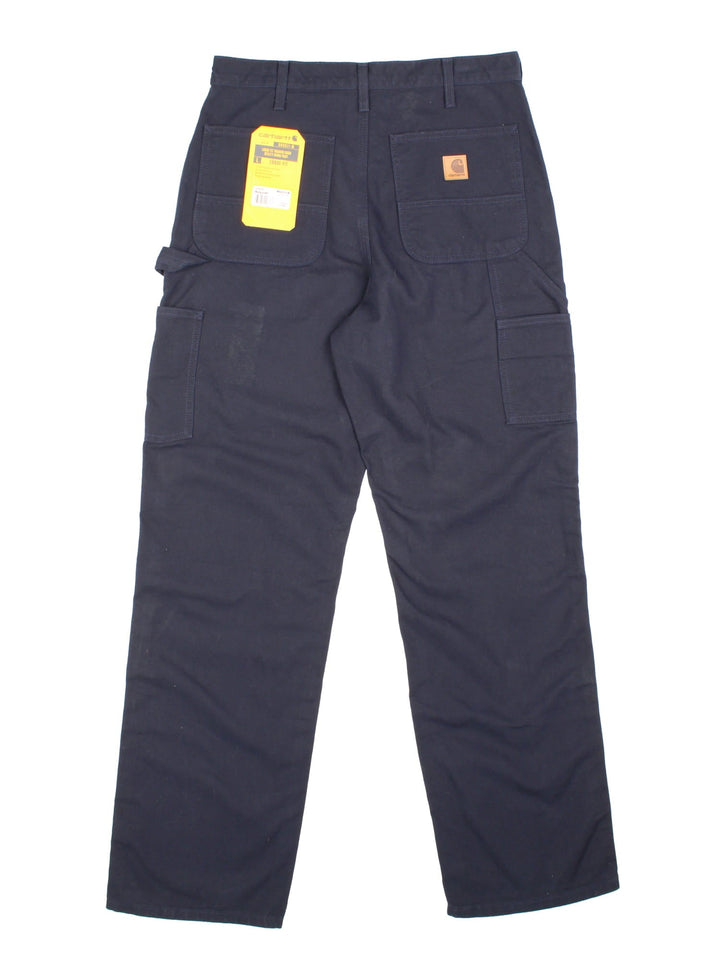 Carhartt Carpenter Jeans in a navy blue colourway with multiple pockets and the logo embroidered on the back, new with tags still on.