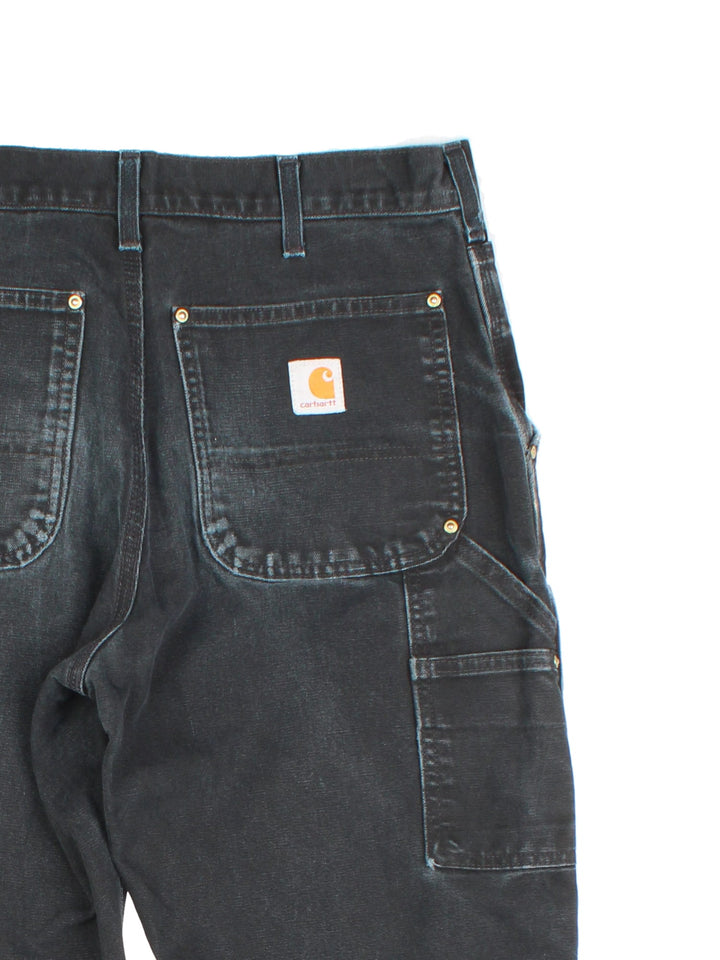 Carhartt Double Knee Jeans in a black colourway with multiple pockets and the logo embroidered on the back.