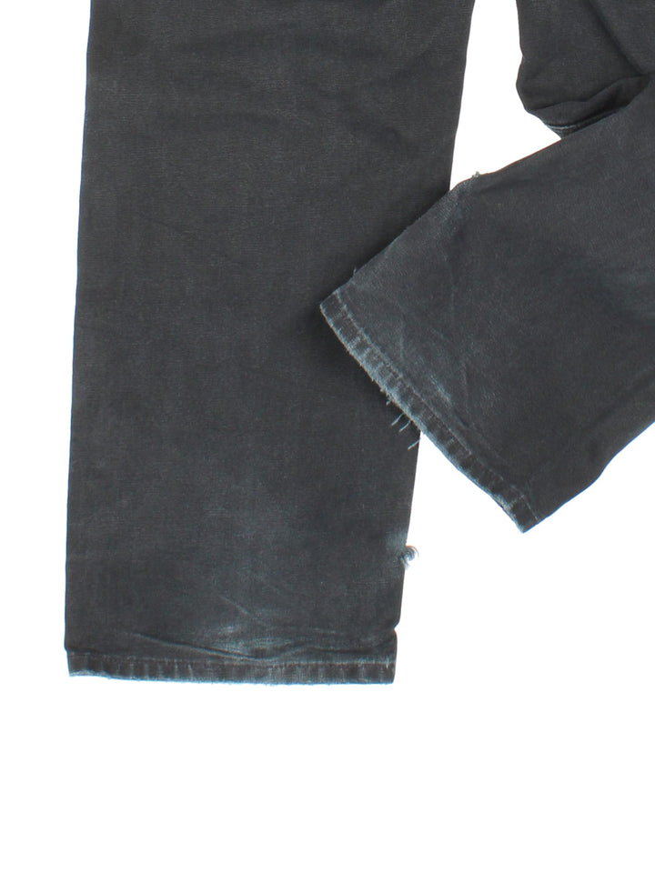 Carhartt Double Knee Jeans in a black colourway with multiple pockets and the logo embroidered on the back.