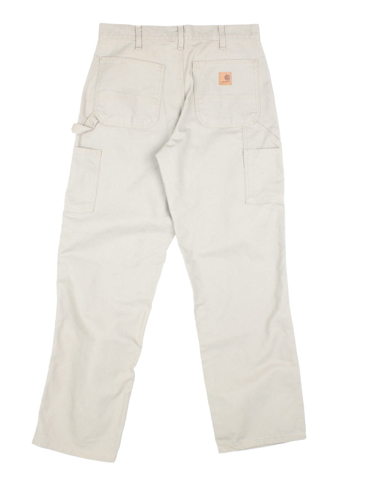 Carhartt Carpenter Jeans in a desert tan colourway with multiple pockets and the logo embroidered on the back.