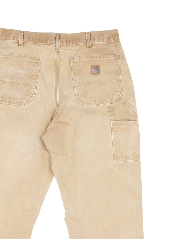 Carhartt Carpenter Jeans in a tan colourway with multiple pockets and the logo embroidered on the back.