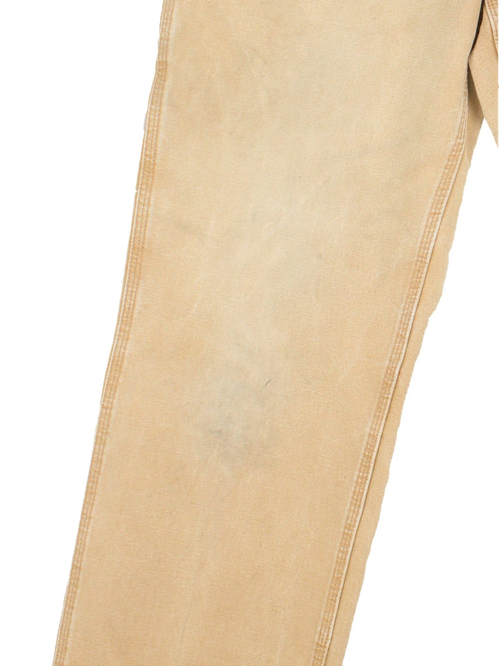 Carhartt Carpenter Jeans in a tan colourway with multiple pockets and the logo embroidered on the back.