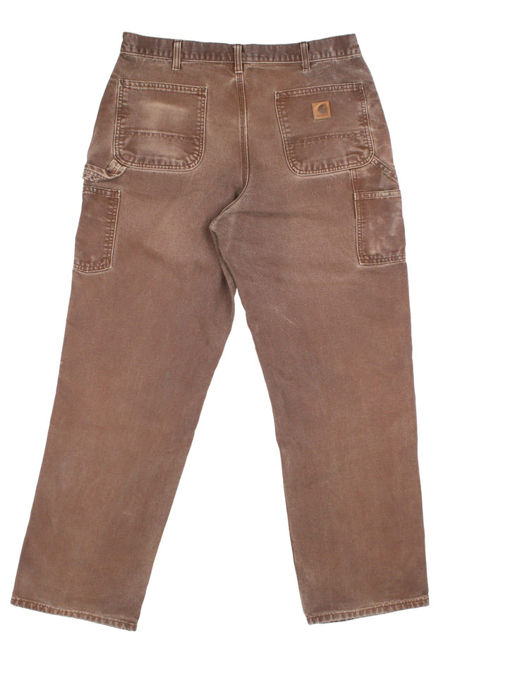 Carhartt Carpenter Jeans in a brown colourway with multiple pockets and the logo embroidered on the back.