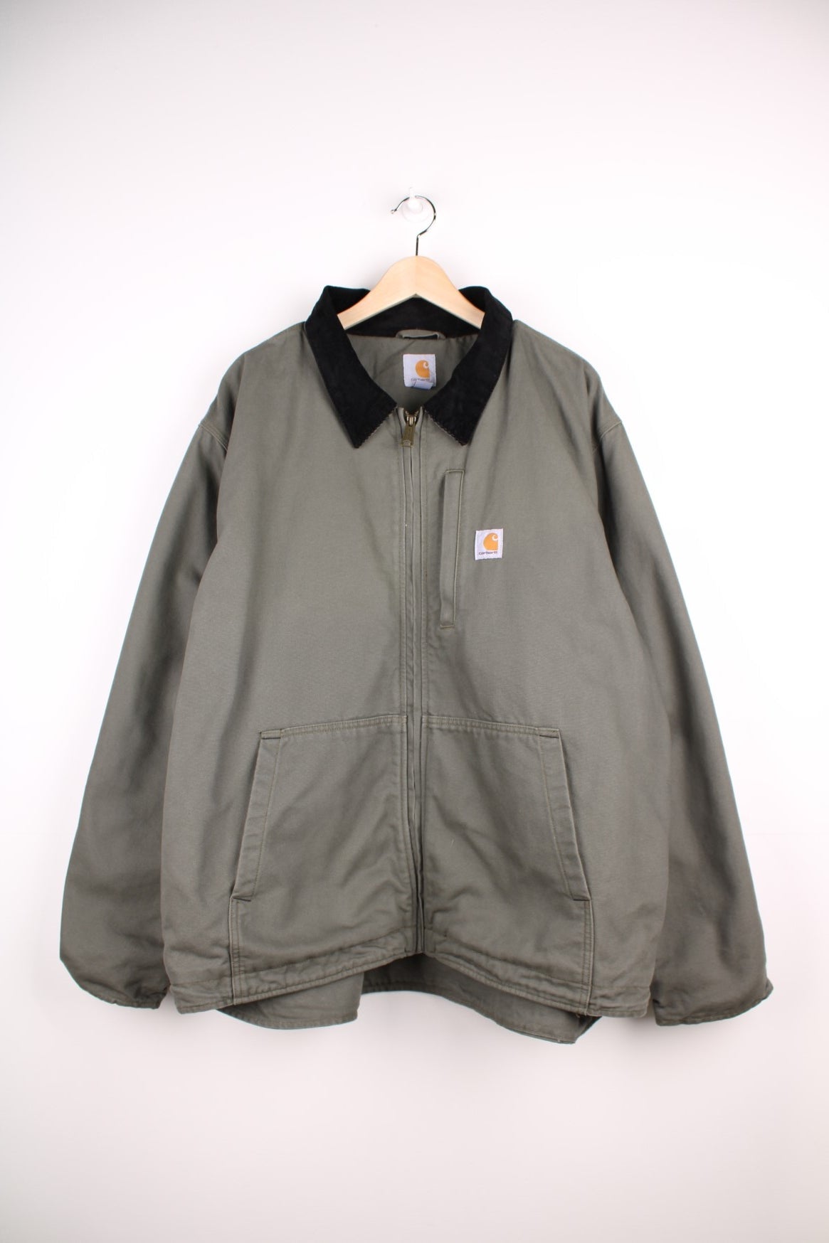 Carhartt Full Swing Workwear Jacket in a green colourway with a black corduroy collar, zips up and has multiple pockets, fleece lined, and has the logo embroidered on the front.