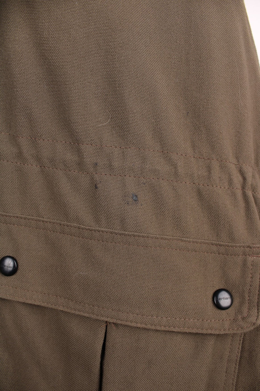 Carhartt C41 Workwear Jacket in a brown colourway, zips and buttons up, has multiple utility pockets, insulated with a quilted lining, and the logo embroidered on the front. 